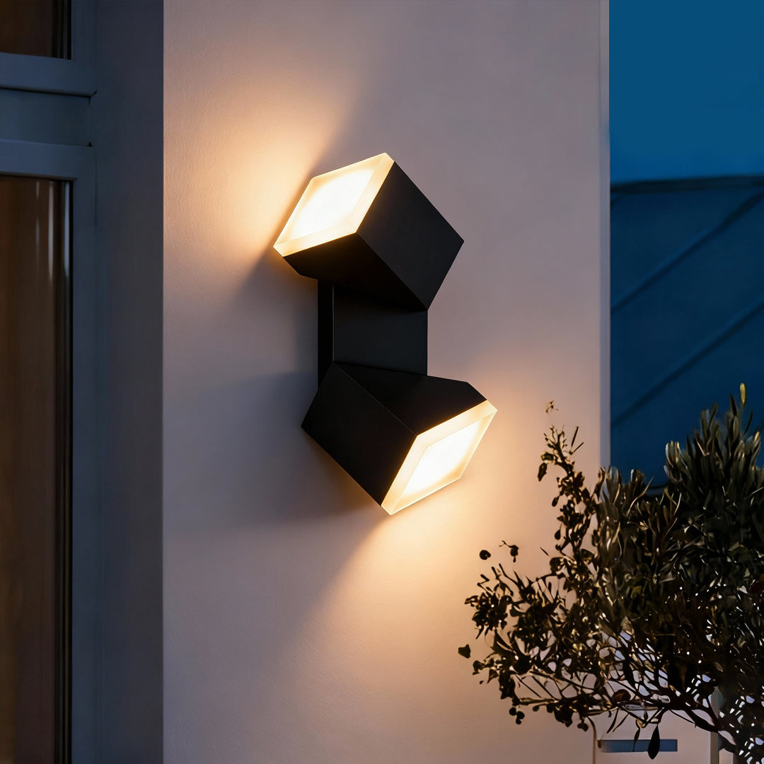 Exterior wall light installed on white siding, producing focused up and down beams influenced by industrial bollard lights design.
