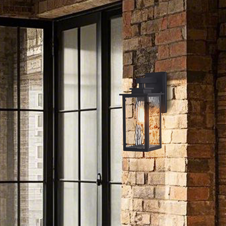 Industrial-style wall sconce illuminating brick exterior with warm atmospheric lighting in modern setting