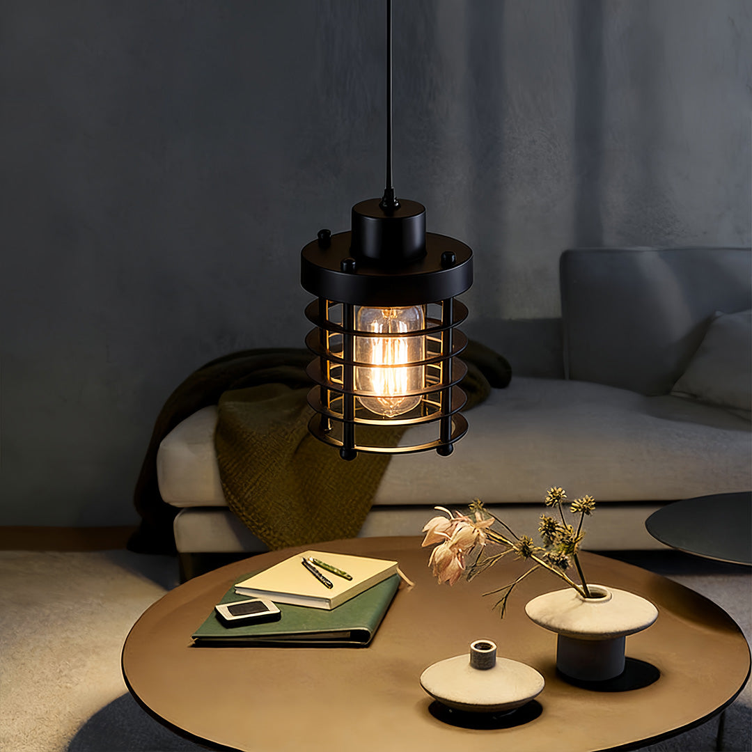 Industrial cage pendant light hanging above a coffee table in a cozy living room.