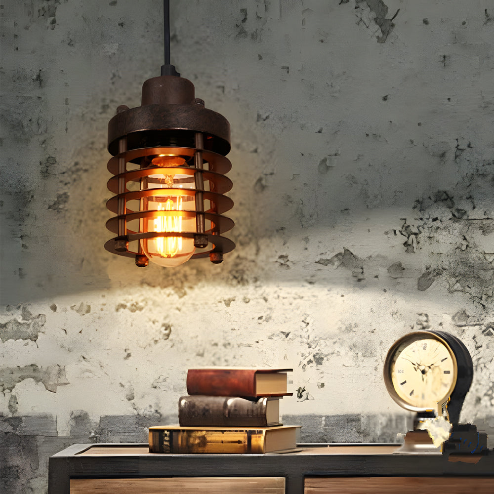 Single industrial cage pendant light illuminating a rustic console table against a concrete wall.