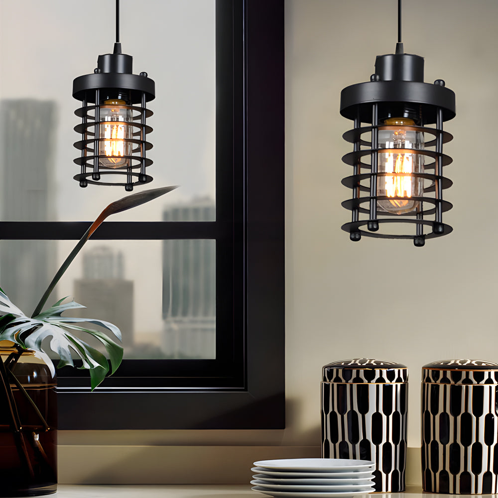 Industrial cage pendant light hanging near a window in a contemporary interior setting.
