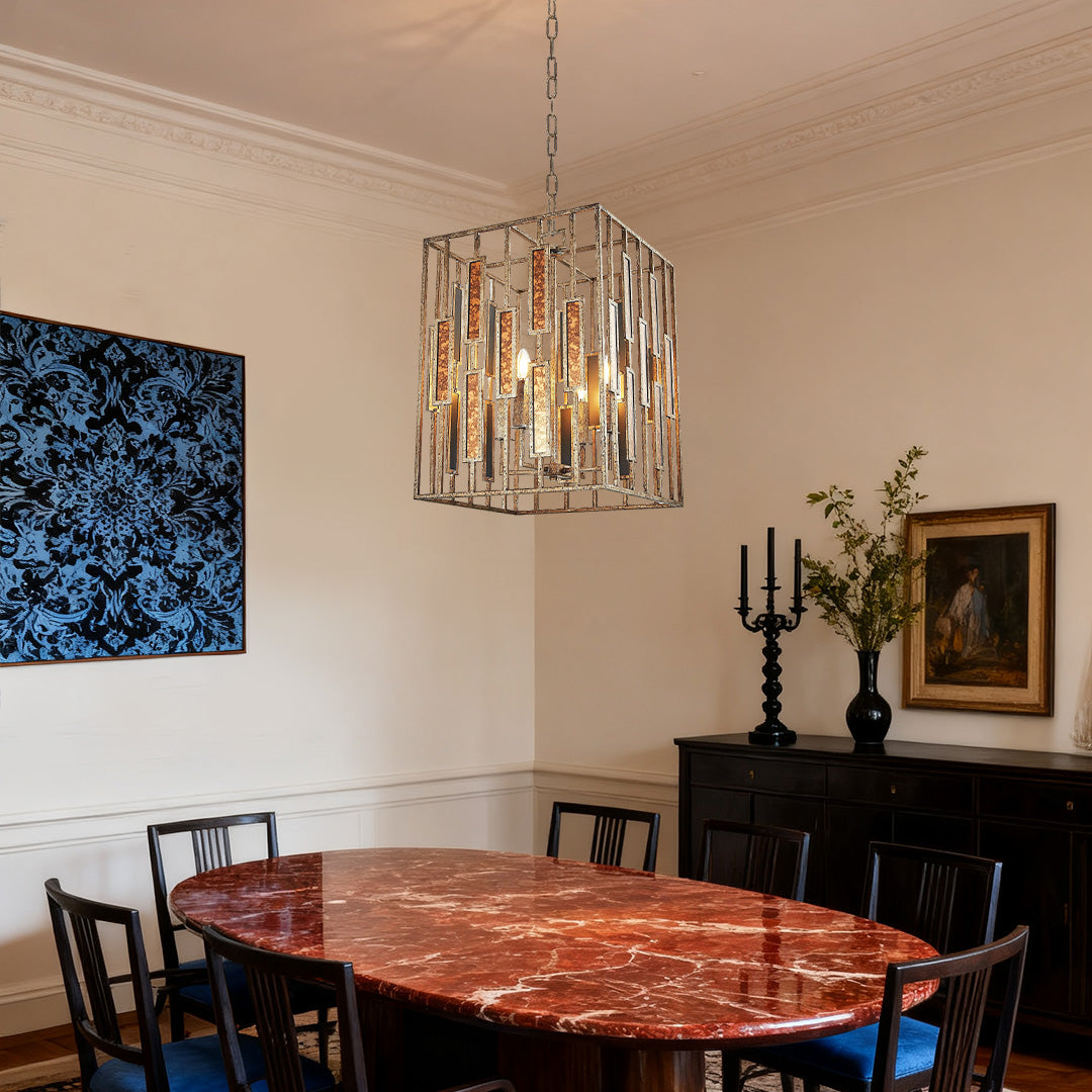 Industrial-chic vintage copper pendant light with a square metal cage and sparkling crystal accents, hanging over a large marble-top table.