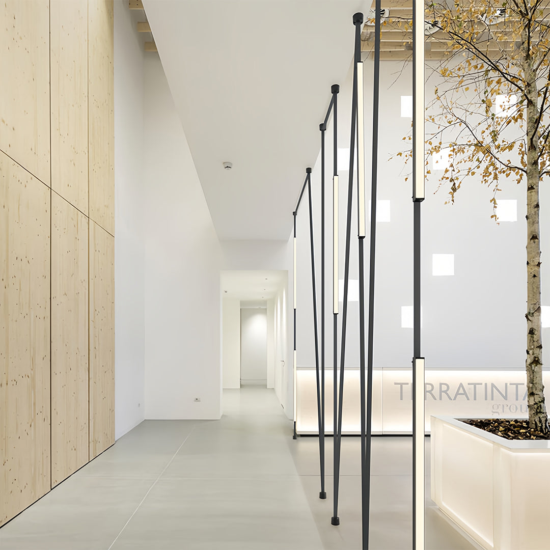 Industrial style hallway with long pendant light fixtures, modern and minimalist lighting design