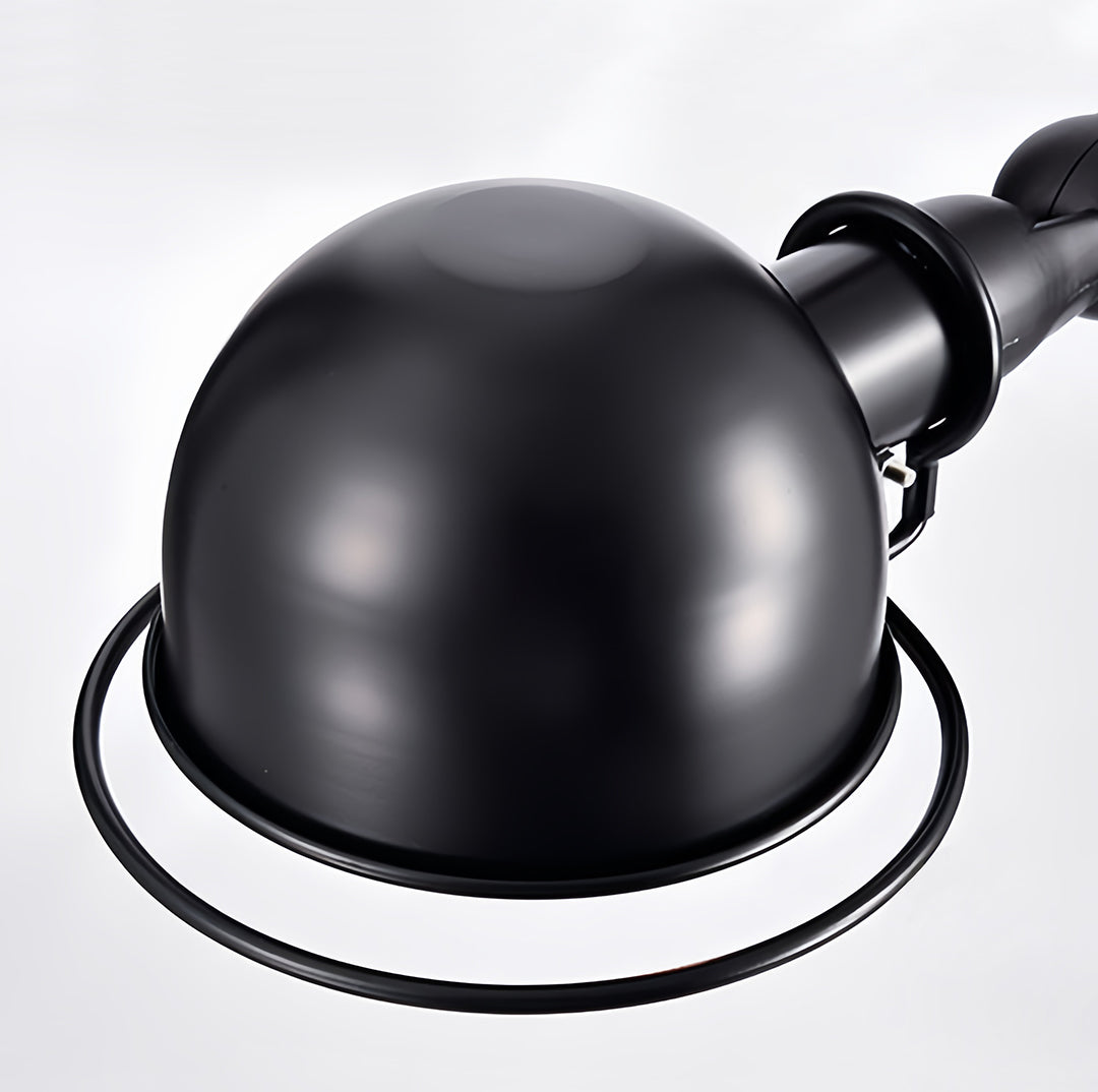 Industrial reading floor lamp with black spherical head and adjustable arm detail showing precision engineering