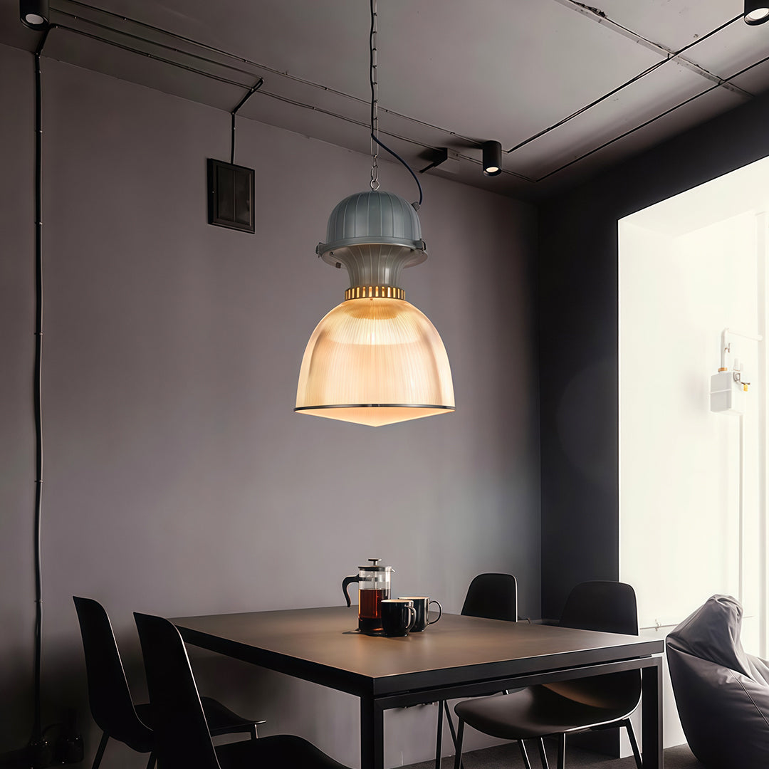 Industrial style pendant lighting illuminating modern black dining room with minimalist table and chairs