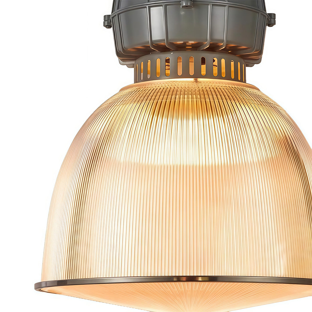 Close-up detail of industrial style pendant lighting showing ribbed glass texture and bronze metal finish