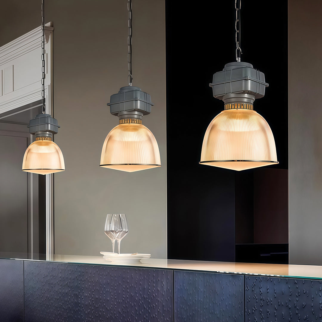 Three industrial style pendant lighting fixtures creating layered illumination in modern kitchen bar area