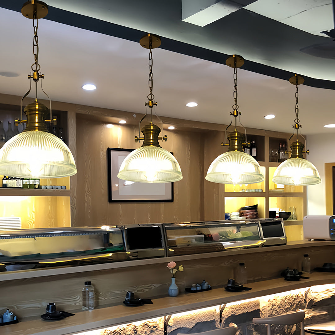 Industrial textured glass pendant lights in contemporary restaurant setting with exposed ceiling and modern fixtures