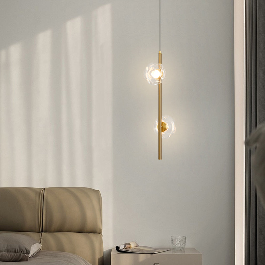 Industrial modern vertical pendant light with exposed elements in minimalist bedroom setting