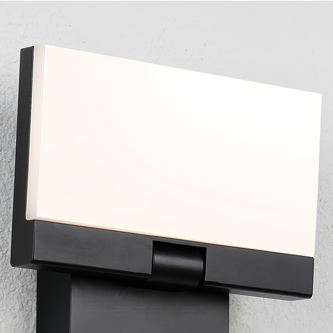 Close-up of industrial wall light showing bright LED panel and modern mounting hardware