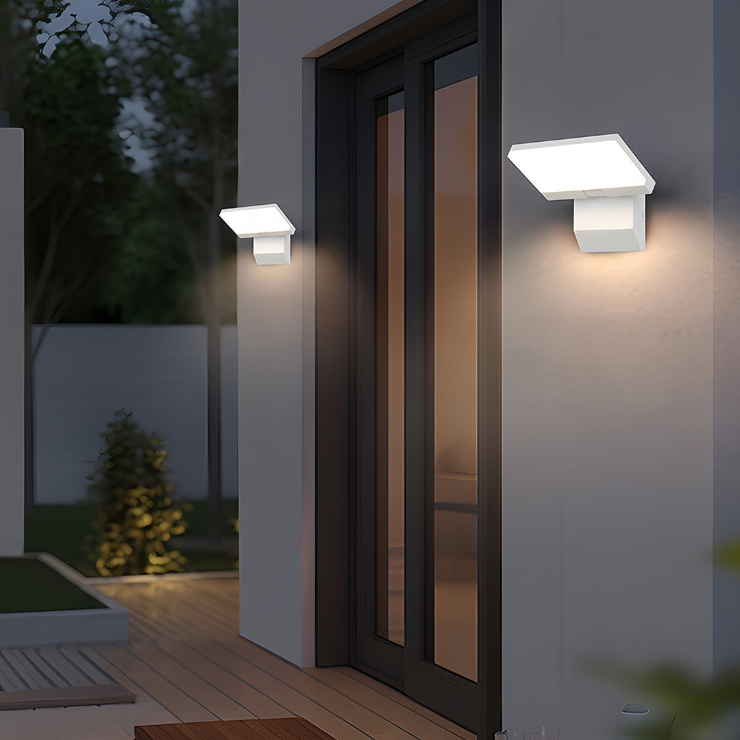 Industrial wall lights creating welcoming entrance lighting on contemporary home with glass doors