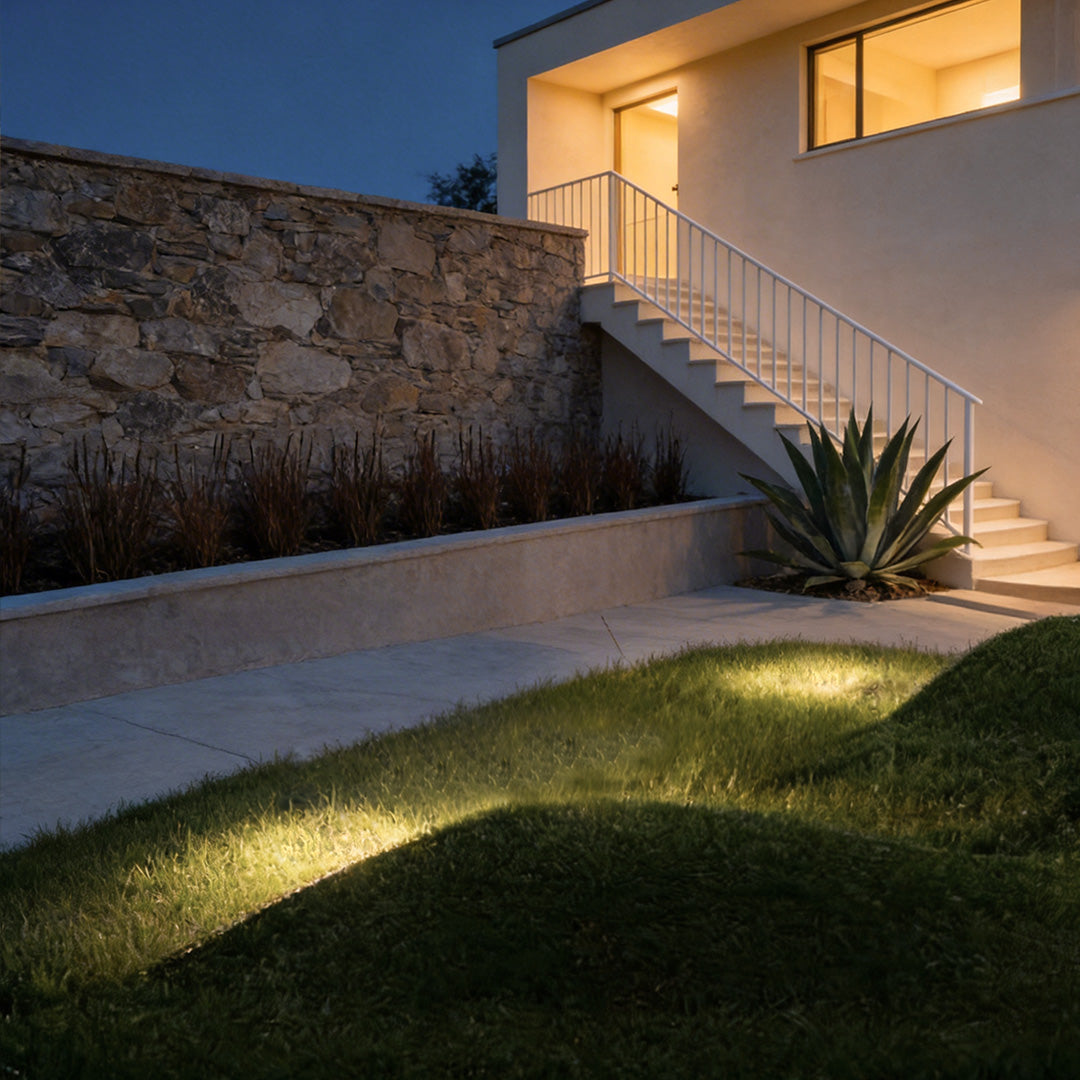 Inground landscape lights with a contemporary design, enhancing a backyard garden.