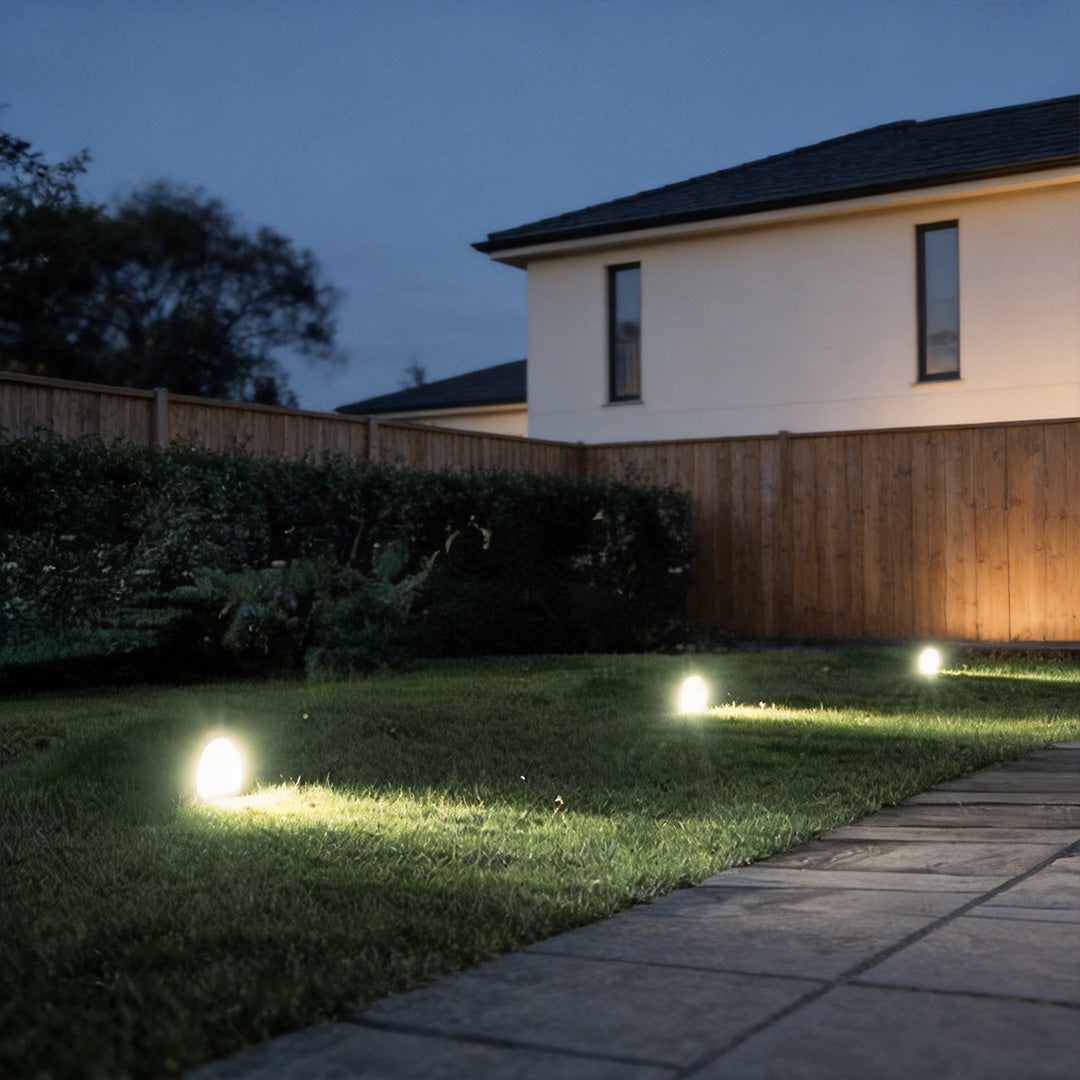 Inground landscape lights with a modern design, providing soft illumination near a staircase.