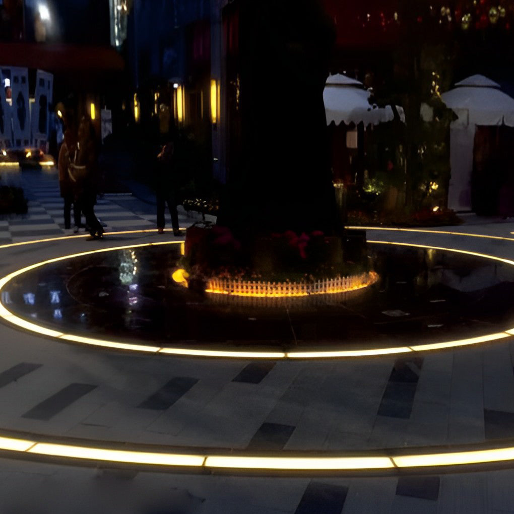 Inground linear lighting providing soft illumination along a modern sidewalk.