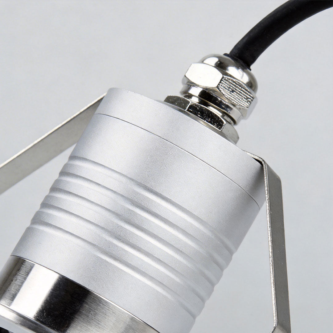 Close-up of inground well light showcasing its stainless steel finish.
