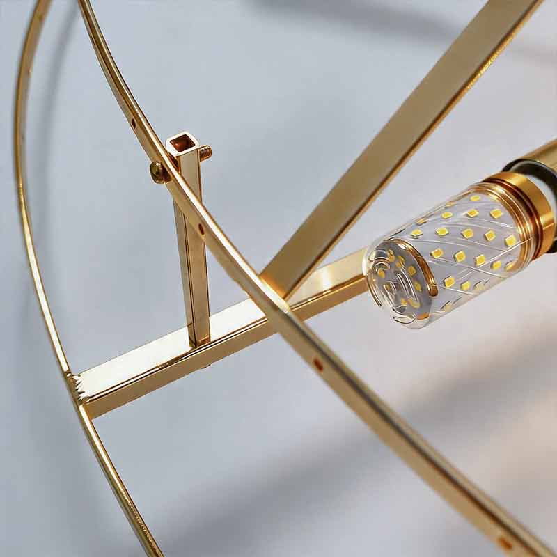 Close up of the inner gold metal frame and led bulb of a round drum crystal chandelier​ fixture