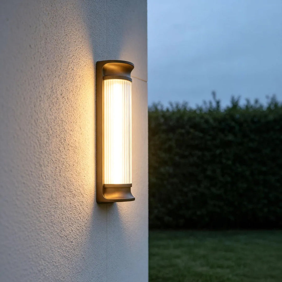 LED outdoor wall sconces installed on an exterior wall providing warm architectural lighting.