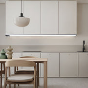 Modern kitchen ambiance created with sleek wireless under cabinet lighting strip above the dining area.