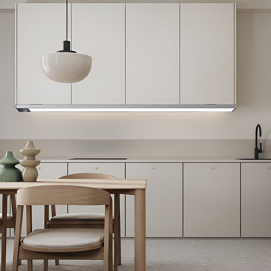 Modern kitchen ambiance created with sleek wireless under cabinet lighting strip above the dining area.