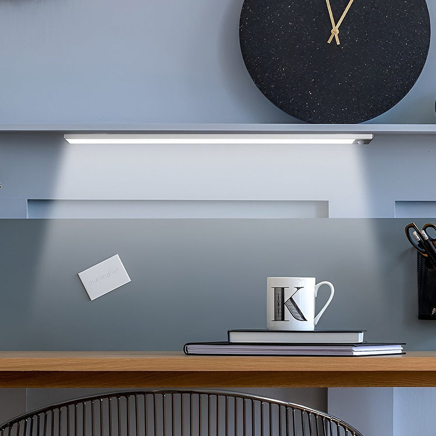 Sleek home office illumination provided by a magnetic wireless under cabinet lighting bar above the desk space.