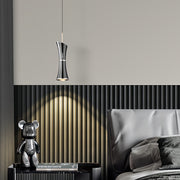 Interior scene featuring small black pendant light illuminating contemporary dining space