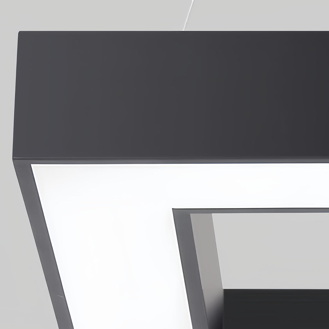 Interior of a stylish space with modern black chandeliers overhead, creating a clean, high-end look.