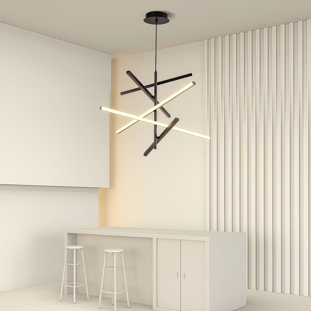 Iron linear chandelier installed in minimalist beige room with white furniture and wood accent wall.