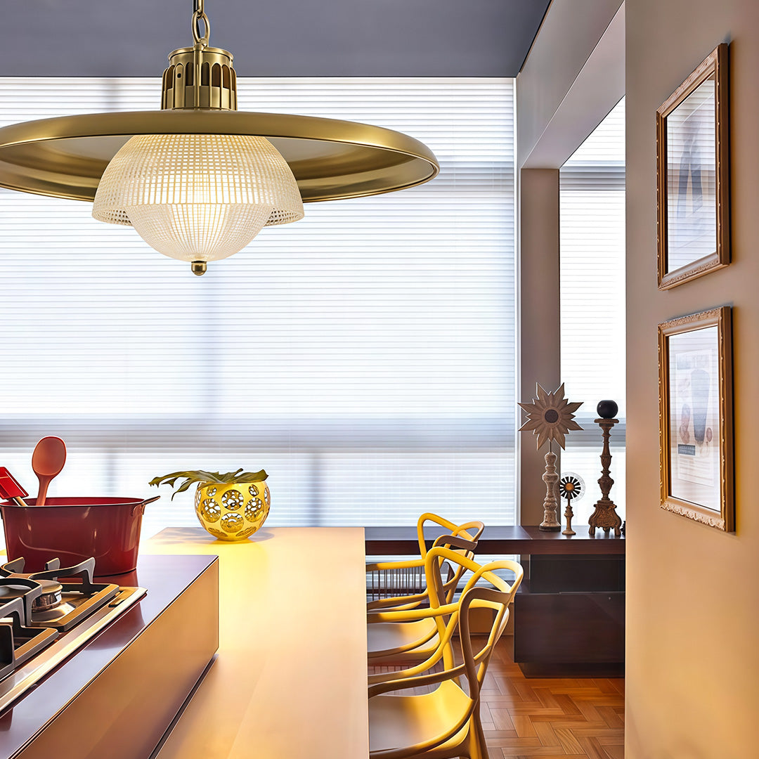 Iron pendant light fixture creating focal point above kitchen workspace with vintage-inspired brass and glass design