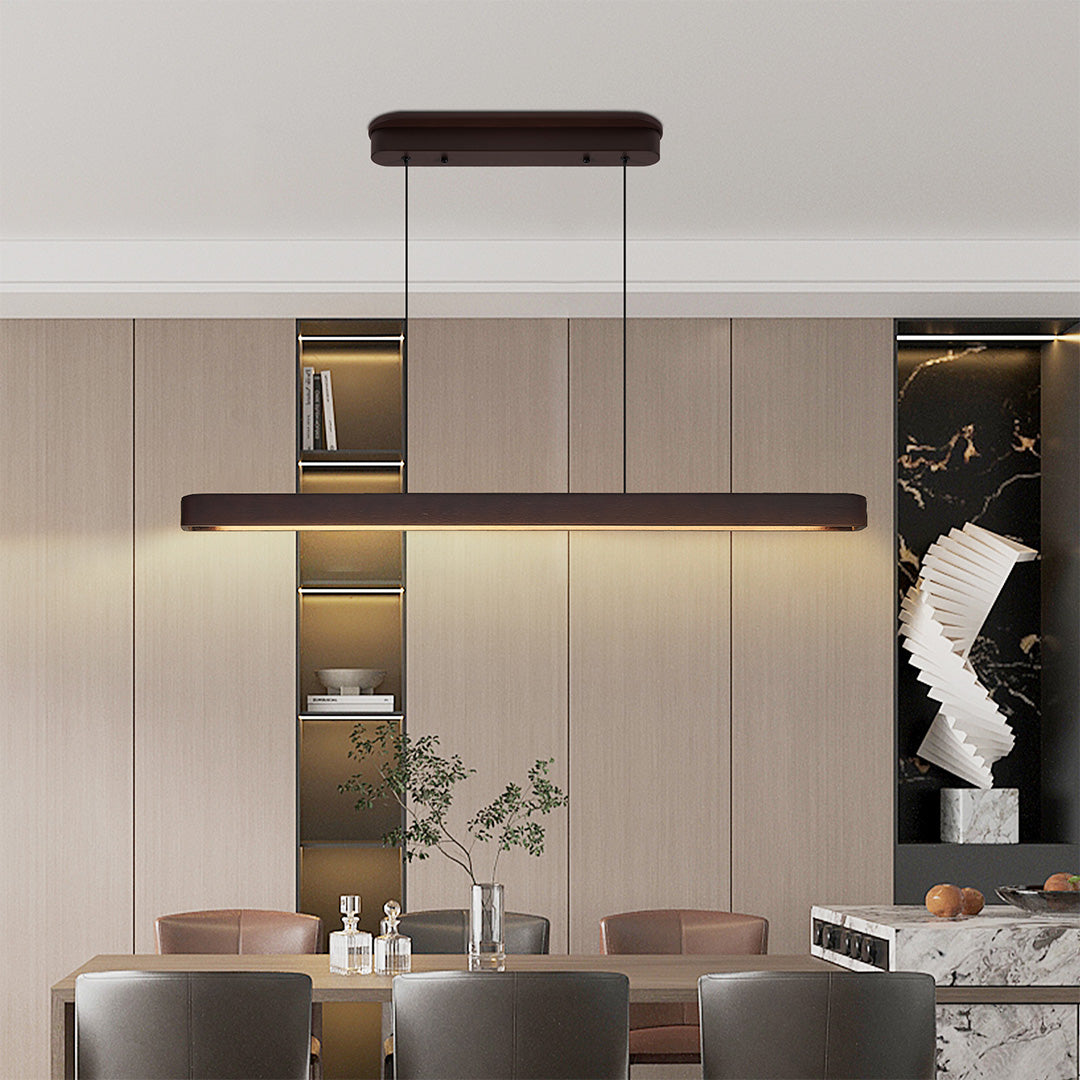 Stylish kitchen area featuring linear LED pendant lighting, blending contemporary design with warm light.