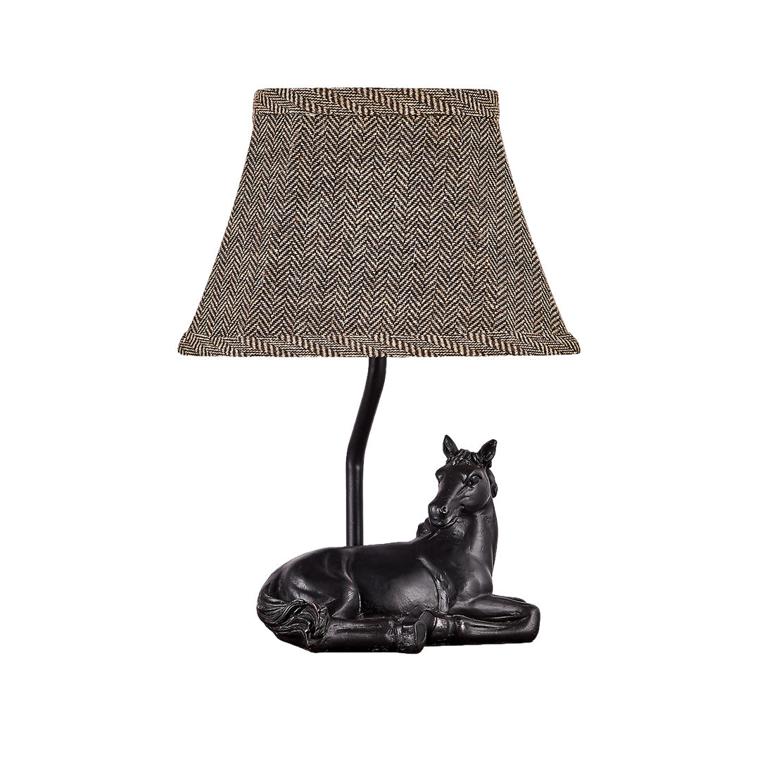 Isolated product view of the table lamp horse with a black resin base and a patterned brown fabric trapezoidal shade.