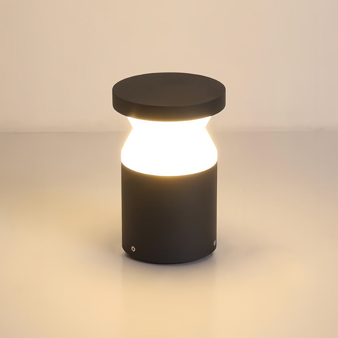 Close-up isolated view of the modern path lights fixture on a bright surface, showing the dark grey post and white diffused light.