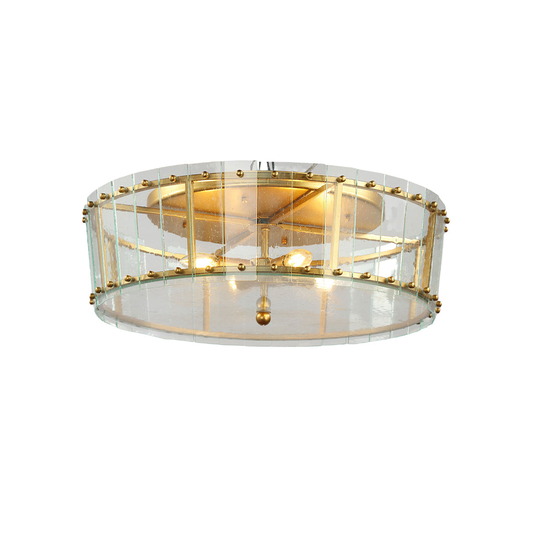 Isolated view of the decorative flush mount gold light, showcasing its interior candelabra lights and the geometric brass detailing.