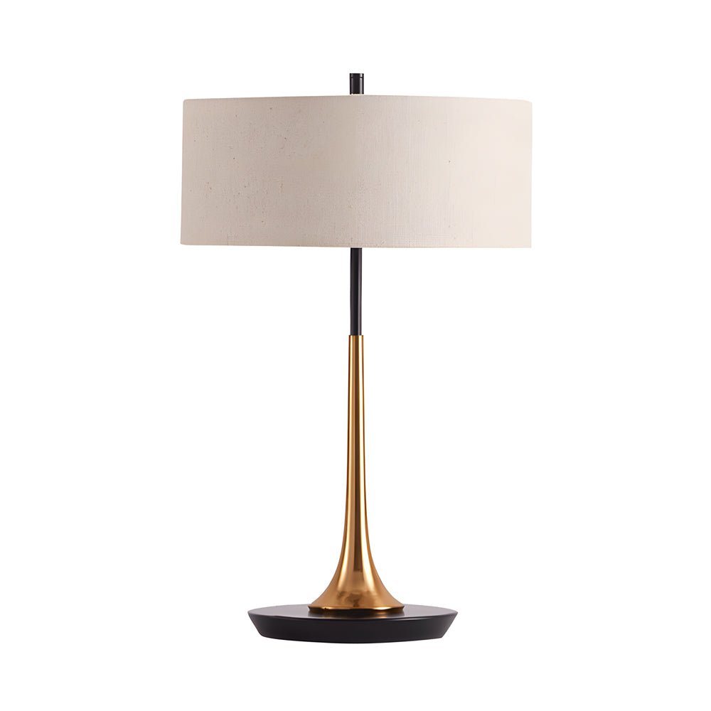 Isolated fabric table lamp with cream linen drum shade and gold trumpet base on white background.