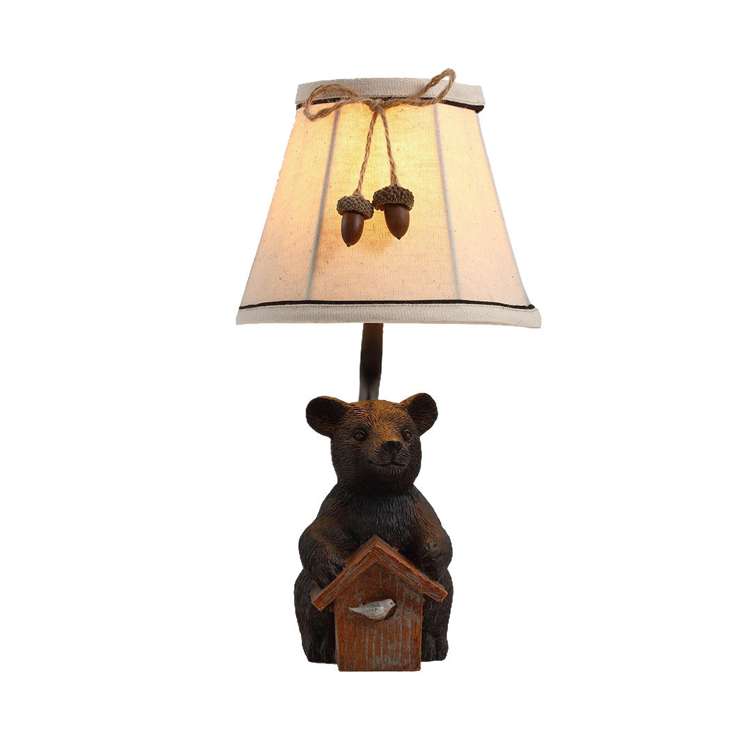 Isolated view of the bear table lamp, highlighting the textured resin base and the acorn details on the fabric shade.