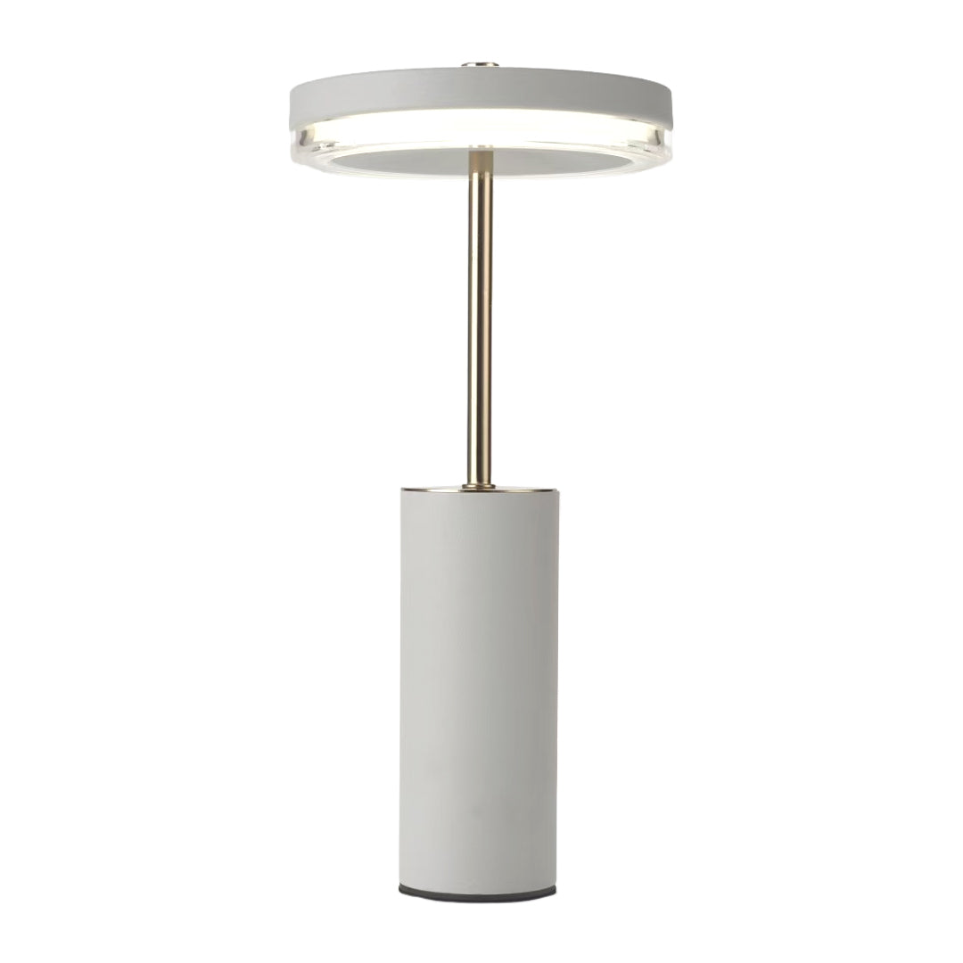 Isolated view of the white cylinder table lamps highlighting the gold accents and opaque cylinder base.