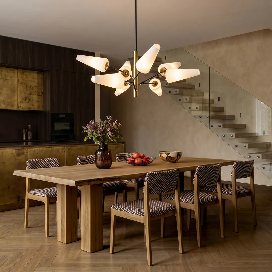 Italian glass chandelier hanging above a wooden dining table in a modern dining room with warm neutral tones.