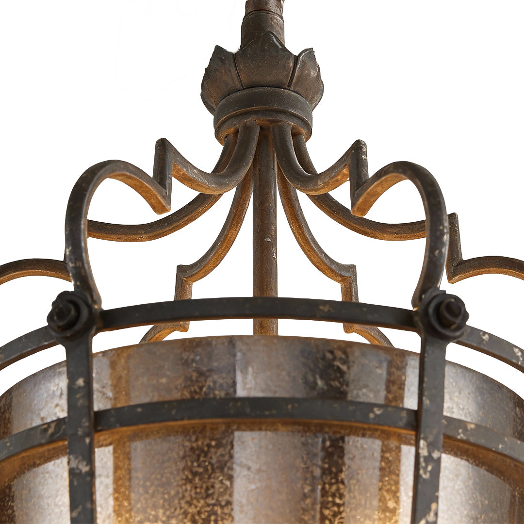 Close-up of an italian pendant light showcasing intricate bronze crown detailing and elegant glass design.