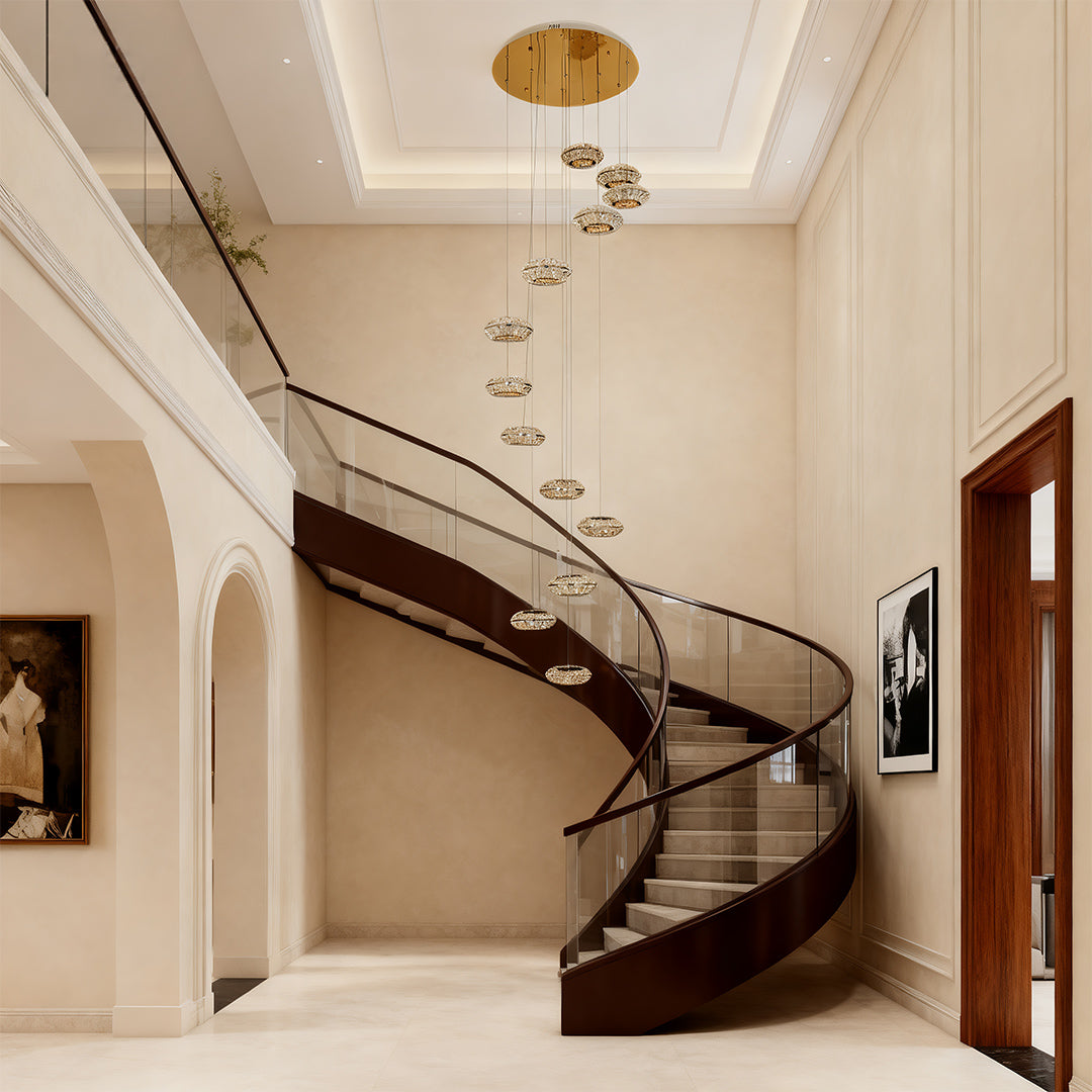 Italian style chandelier hanging above a spiral staircase, providing sophisticated illumination.