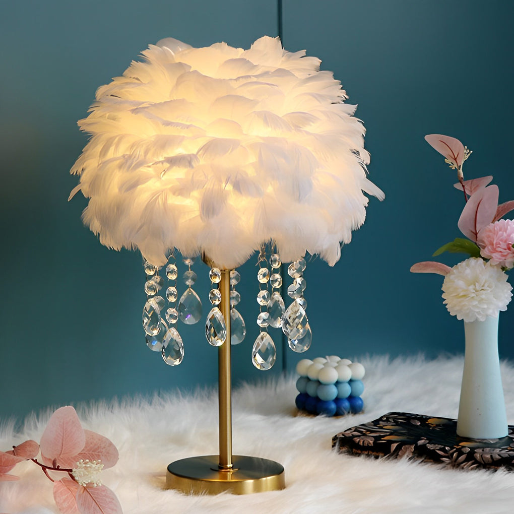 Ivory feather table lamp with crystal strands emitting warm ambient light.