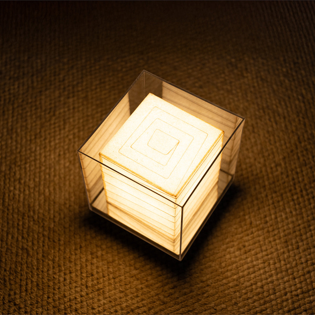 Japanese paper table lamp with clear acrylic case offers soft ambient lighting and a refined minimalist aesthetic for modern interiors.