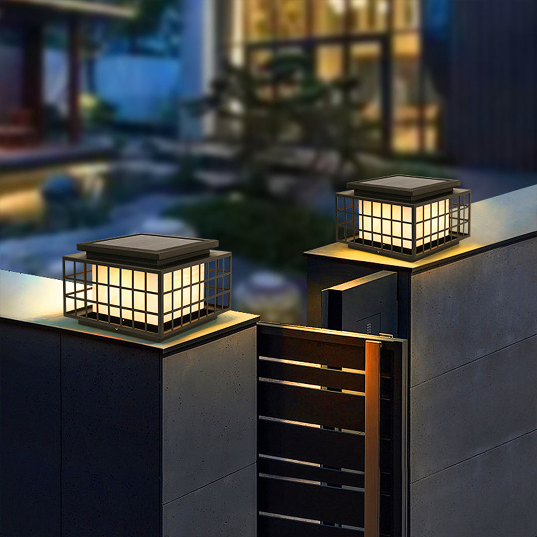 Japanese-style solar lanterns placed on stone surface creating peaceful zen garden atmosphere with natural rock elements