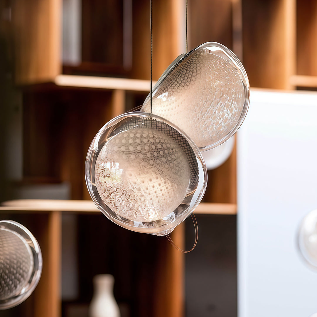 Textured glass jellyfish pendant lights installed above modern dining area.
