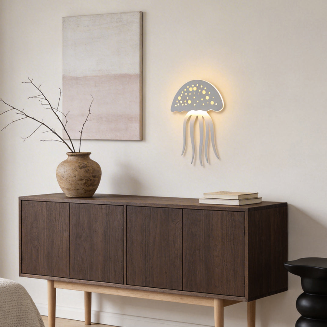 Jellyfish wall light installed above sideboard in modern living room.