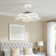 Kids' room ceiling fans white with light and playful pink rainbow accent, installed above a bed with white and pink headboard. 