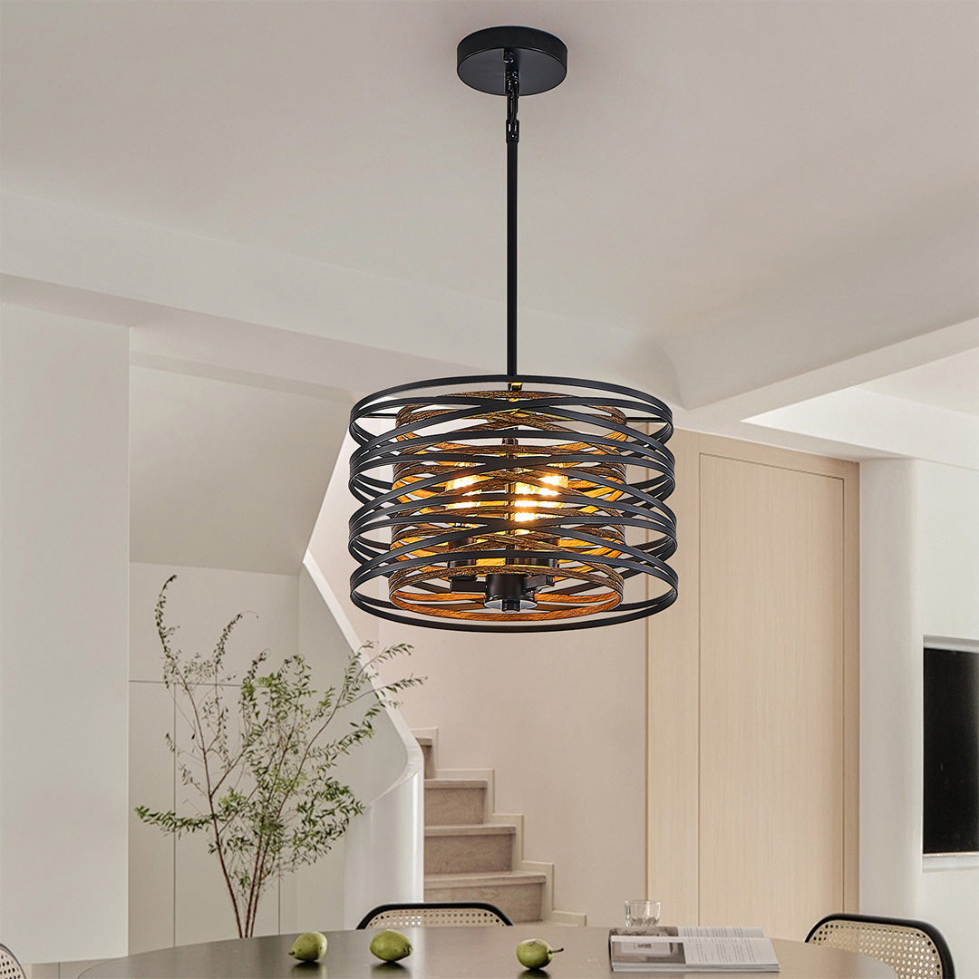 Black drum pendant light illuminating a kitchen island, offering focused task lighting with a modern aesthetic.