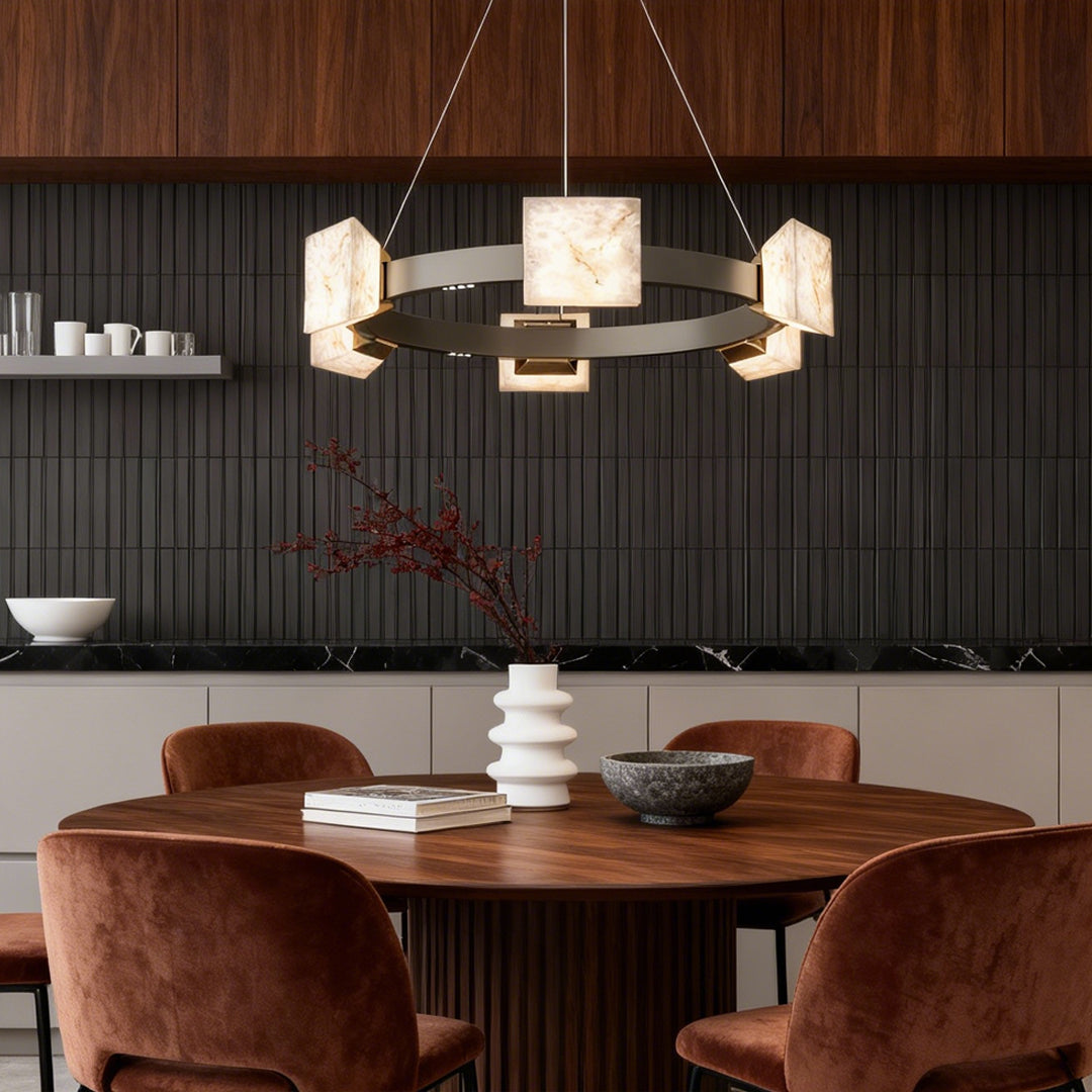 Elegant dining space illuminated by a modern kitchen island chandelier with stone cube lighting elements.