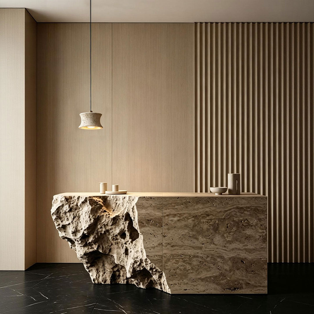Drum pendant light fixture hanging above a sculptural stone kitchen island in a modern interior.