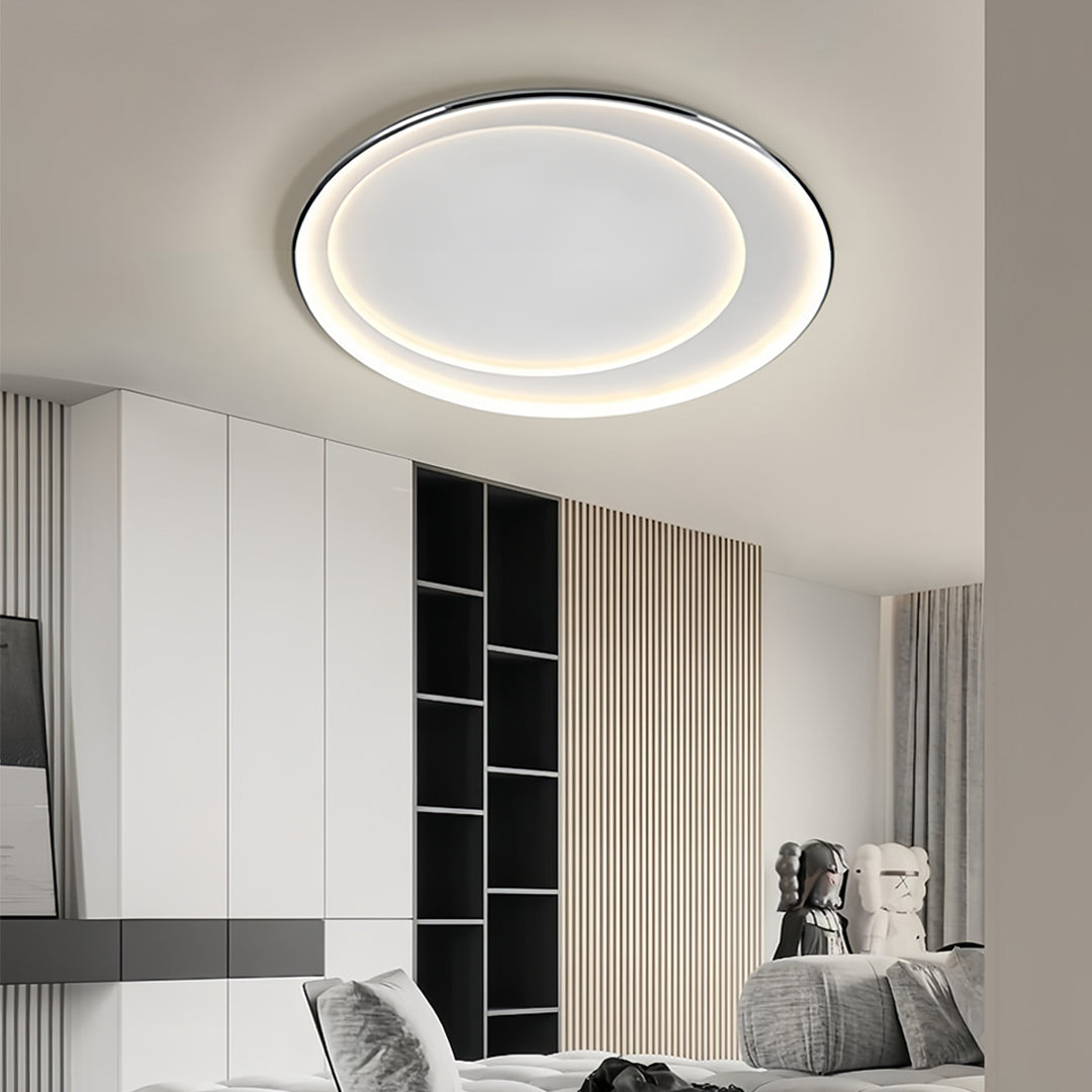 LED round flush mount light providing ceiling illumination in modern kitchen with black cabinetry