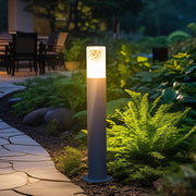 Bright landscape bollard light fixtures lining a backyard garden path, providing warm directional illumination.