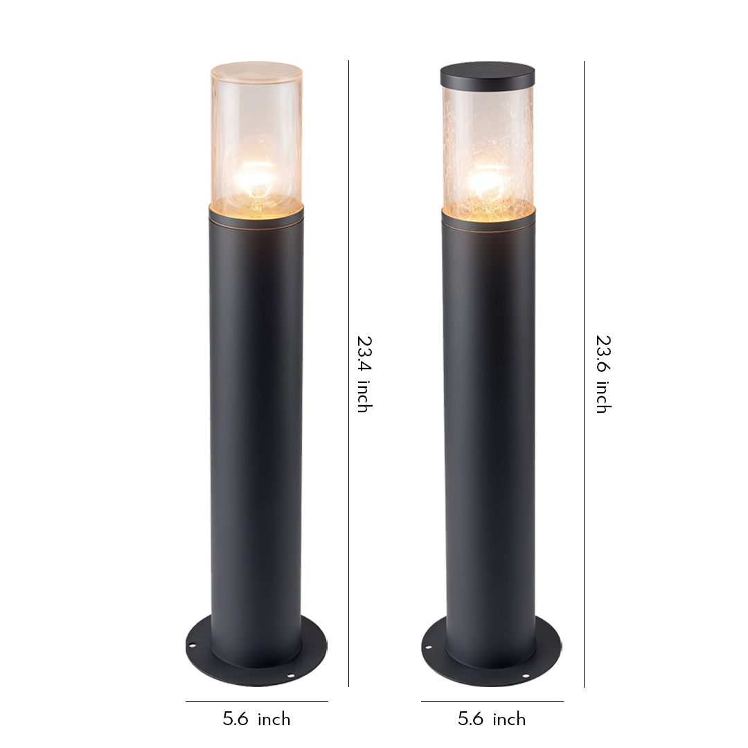 Tall black landscape bollard light fixtures with clear cylindrical top shades for modern outdoor pathways.